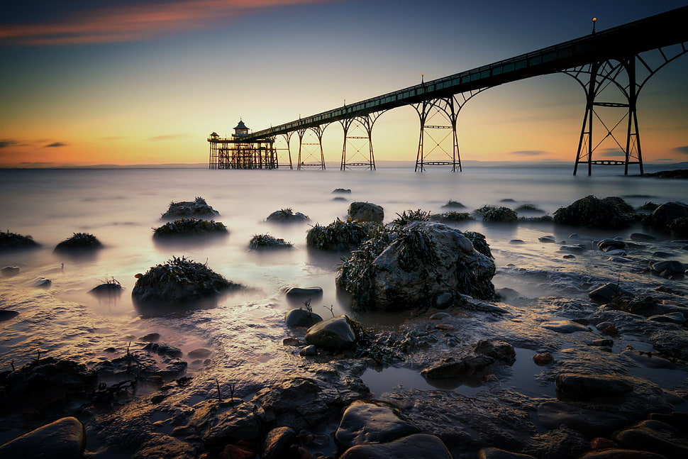 gray rocks on body of water near at bridge, clevedon HD wallpaper