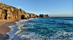 body of water near of rock formation, porthcurno HD wallpaper