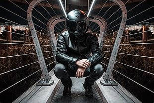 men's black full-face helmet and black leather jacket