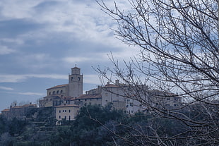 white wall paint and brown roof concrete building under white clouds, croatia