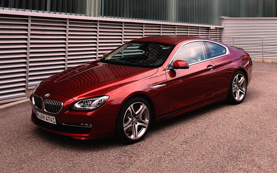 red BMW coupe parked near building HD wallpaper