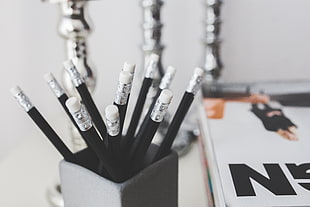 macro photography of black pencil inside the gray box