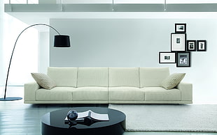white fabric 4-seat sofa in front of black collage photo frame HD wallpaper