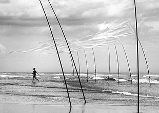 grayscale photo of person running on beach