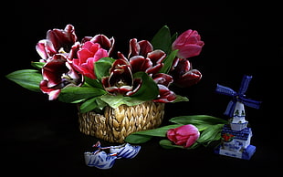 basket of flowers beside windmill figurine