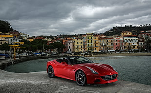 photo of red sports car near on sea HD wallpaper