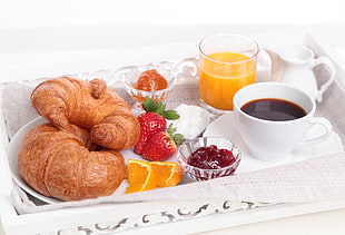 brown croissant bread on plate and coffee