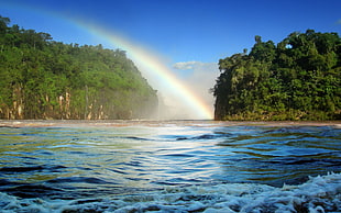 photo of two islands between rainbow HD wallpaper