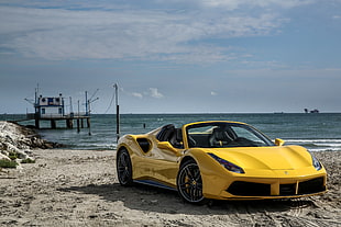 yellow Ferrari 458 Italia car on seashore near dock under white clouds HD wallpaper
