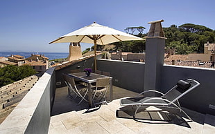 grey patio table with patio umbrella