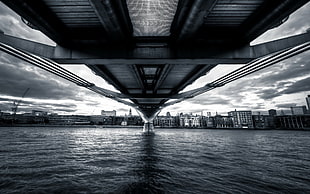 grayscale photo of under bridge, bridge, water, cityscape, sky HD wallpaper