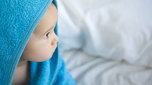 baby with blue bath towel