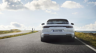 white Posche car on black top road during daytime