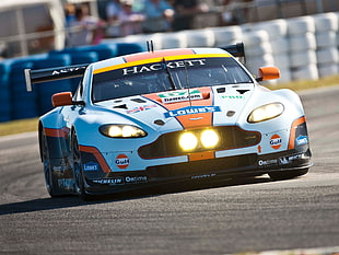 orange and white Aston Martin stock car during daytime HD wallpaper