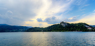 green island under blue cloudy sky