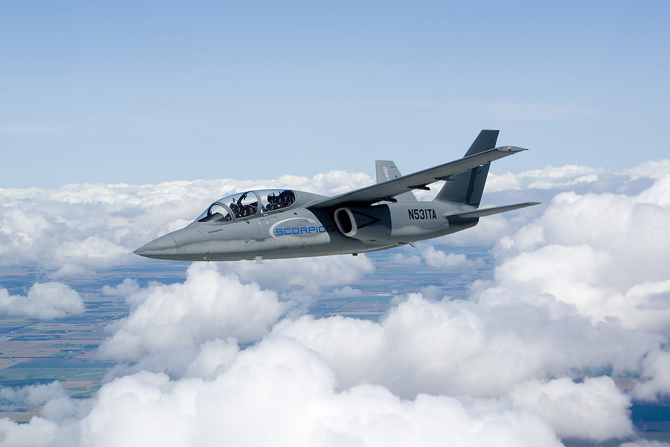 flying grey and blue N52ITA fighter jet above clouds during daytime HD wallpaper