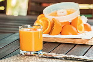 orange juice in clear drinking glass HD wallpaper