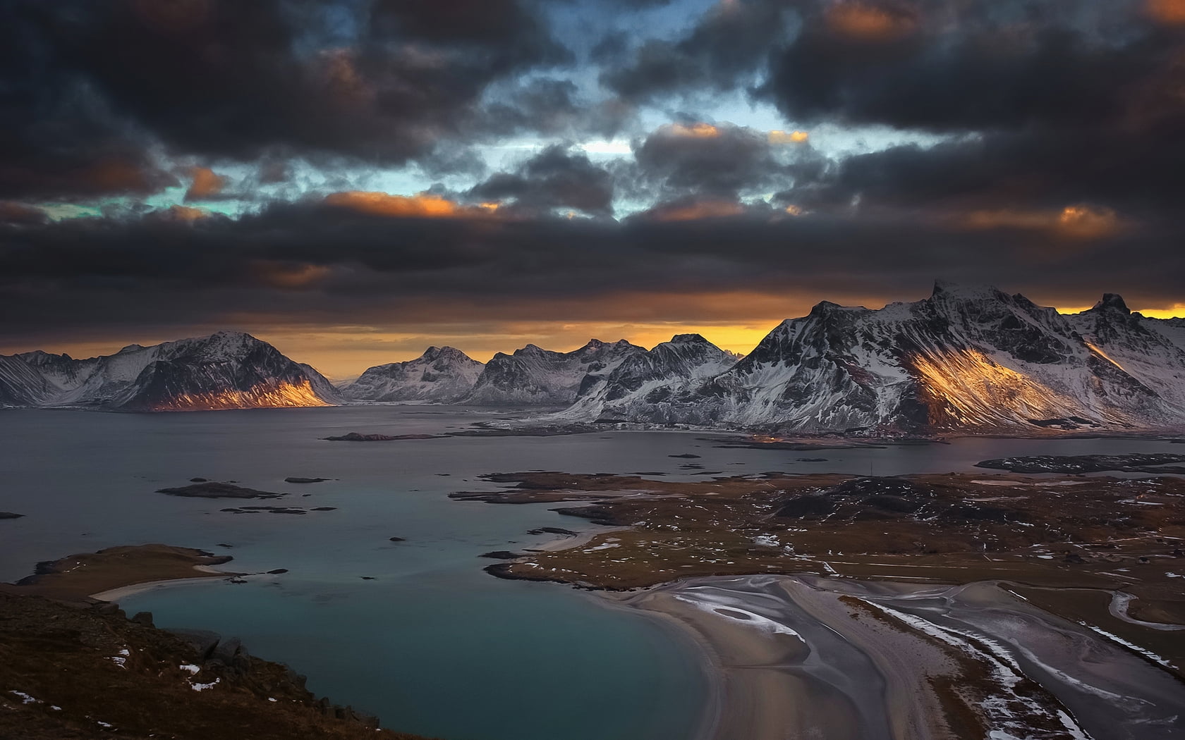 body of water and snow capped mountain under cloudy sky druing sunset landscape photo