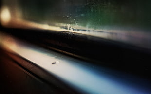 black and gray car amplifier, closeup, depth of field, wood, window