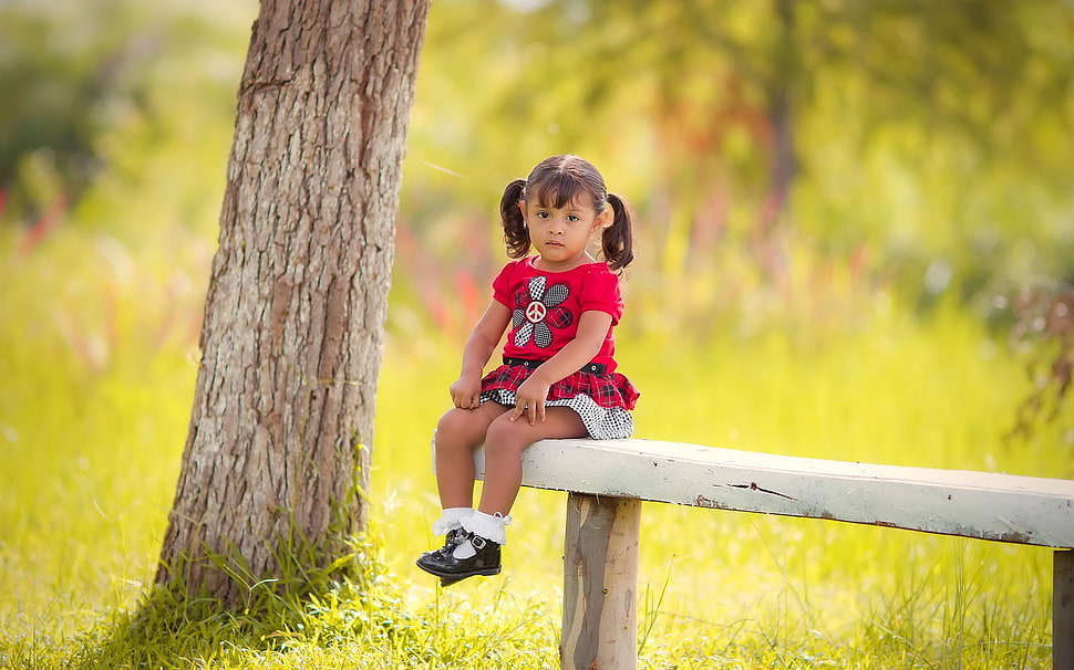 girl wearing pink floral short sitting on white wooden bench HD wallpaper