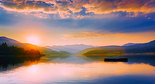 sun rise over mountain near water photo HD wallpaper