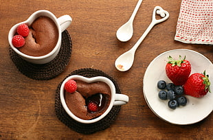 two white ceramic cups and saucers