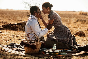 man and woman having picnic at desert during daytime HD wallpaper
