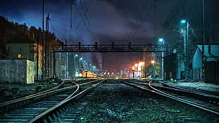 train rails photo during nighttime HD wallpaper