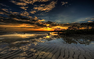 body of water under blue sky