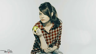 woman wears red and white checkered long-sleeved shirt holds apple fruit HD wallpaper
