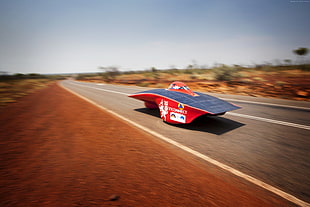 timelapse photography of red car along highway