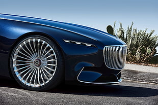 blue Mercedes-Benz car on black top road