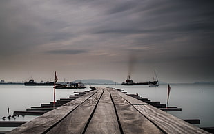 brown wooden sea dock in distant of three ships, georgetown HD wallpaper