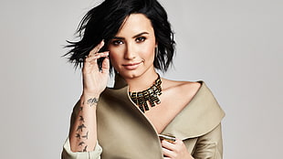 woman wearing brown leather top and gold-colored necklace