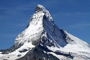 aerial photography of snow covered mountain under blue clear sunny sky