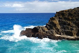 aerial photography of rock formations on the sea