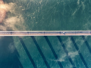 gray concrete bridge over body of water