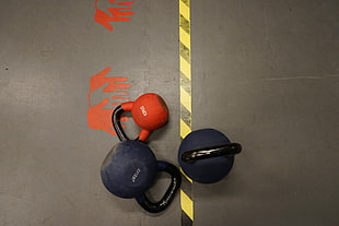 three black-and-orange kettle bells HD wallpaper