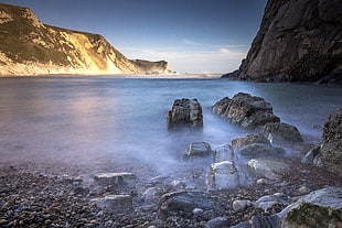 rock formation on body of water during daytime, dorset HD wallpaper