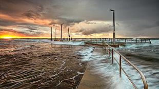 time-lapse photography of sea waves on walkway HD wallpaper