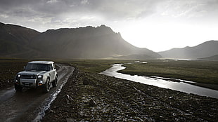 gray and black Land Rover Range Rover on black top road