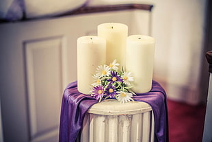 three white pillar candles