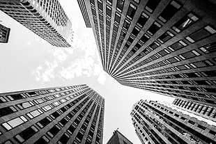 grayscale photo low angle of view of high-rise buildings