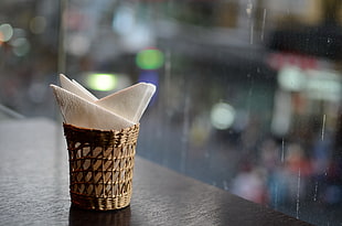 brown wooden tissue holder on black wooden table