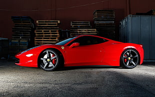 red Ferrari supercar parked on near the wood palette HD wallpaper