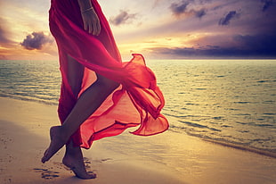 woman in red dress walking in front of beach HD wallpaper