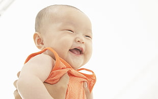 baby wearing orange tank top HD wallpaper