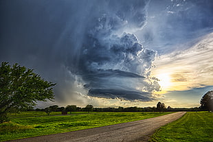 photo of cloudy sky and green grass field