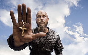 man in chainmail holding gold-colored cross pendant HD wallpaper