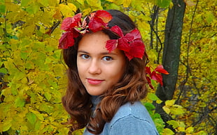 woman wearing blue top and red flower headband beside trees HD wallpaper
